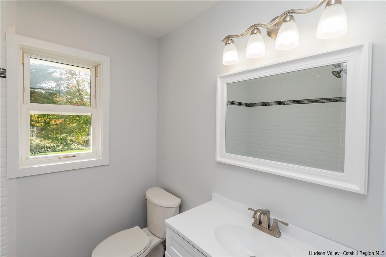 79 Kings Hill Road Walden, NY 12586 - Photo 12 of 35 a bathroom with a toilet sink and mirror