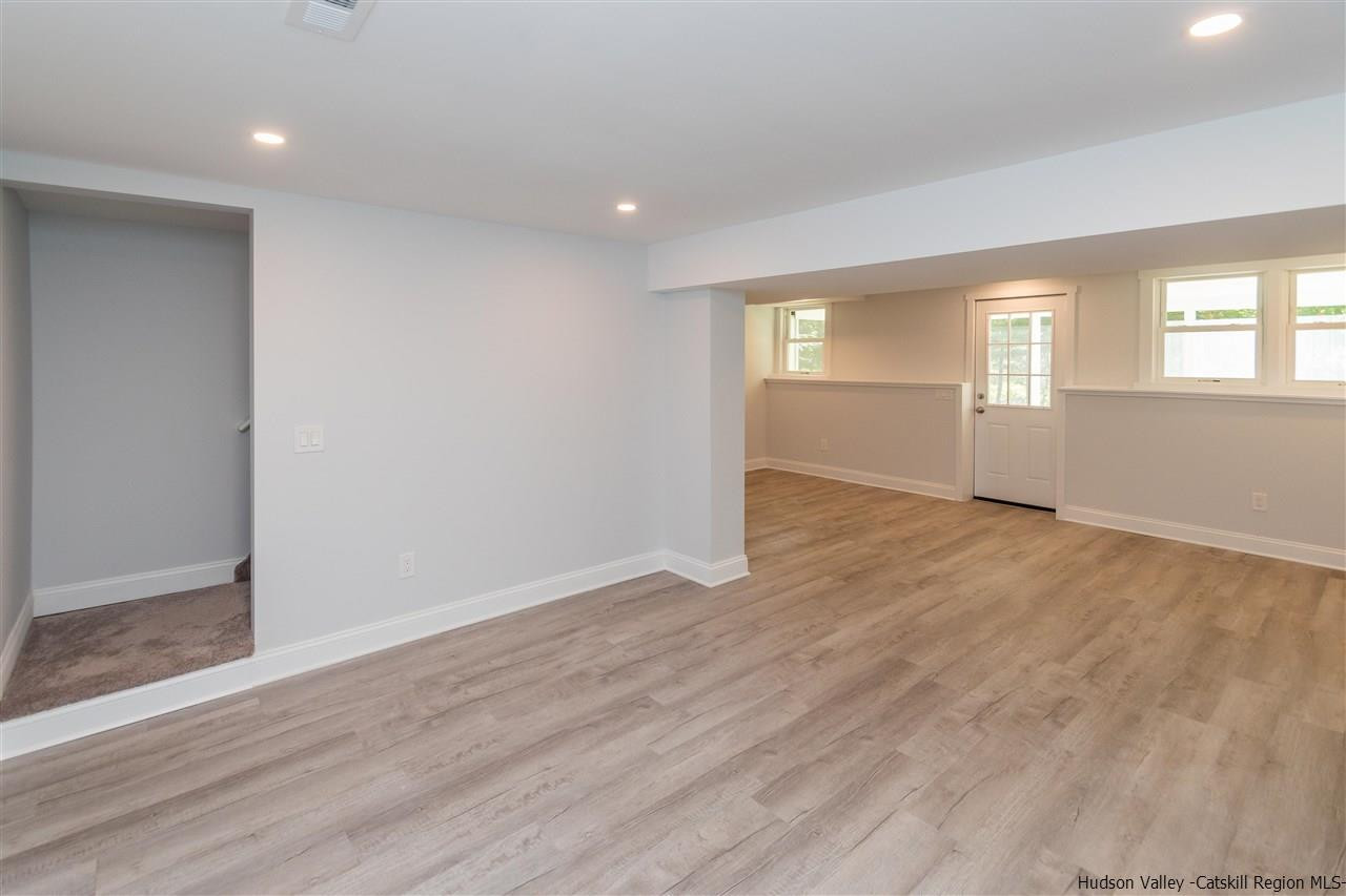 79 Kings Hill Road Walden, NY 12586 - Photo 18 of 35 an empty room with wooden floor and windows