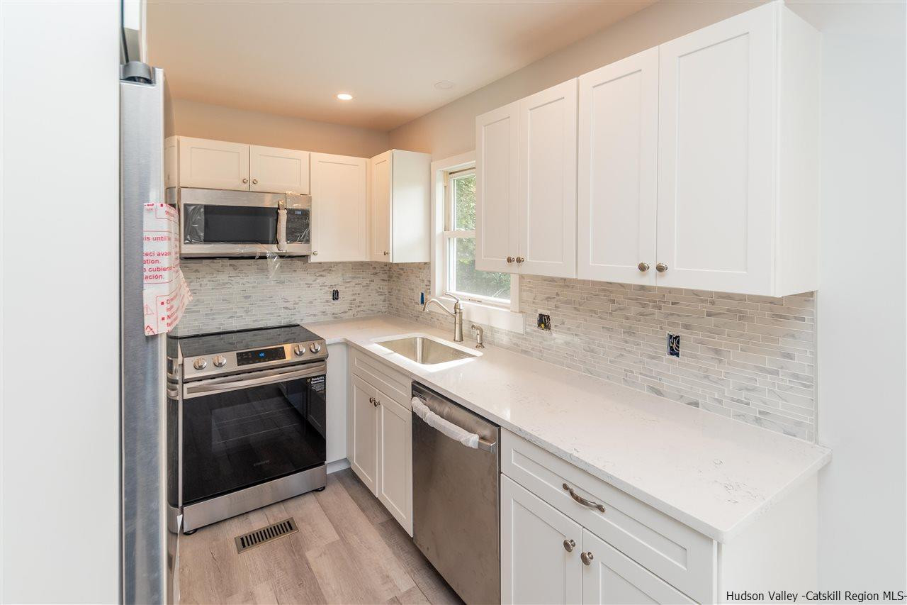 79 Kings Hill Road Walden, NY 12586 - Photo 4 of 35 a kitchen with a sink stove and microwave