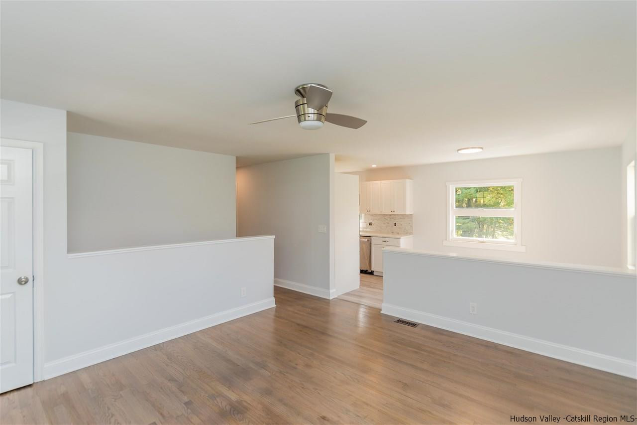 79 Kings Hill Road Walden, NY 12586 - Photo 9 of 35 an empty room with wooden floor and windows