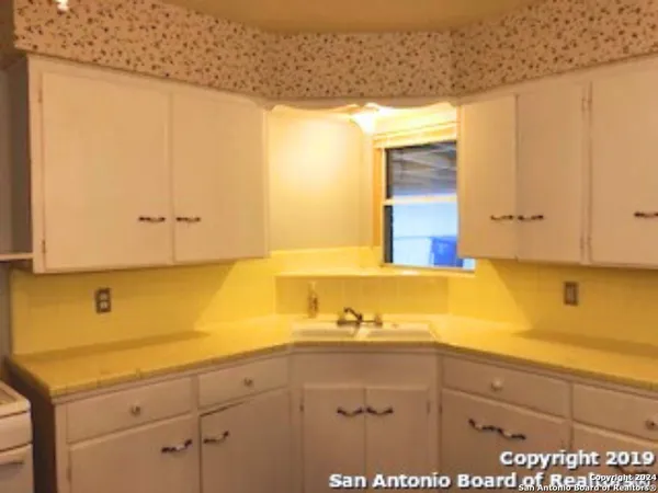 a bathroom with a sink and mirror