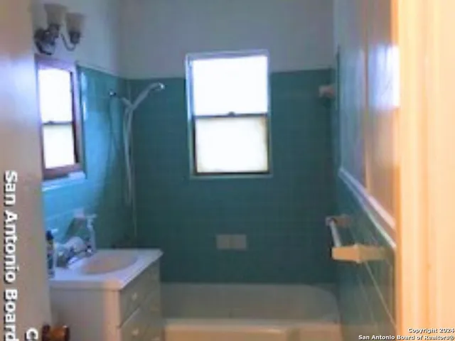 a view of a chandelier fan and fire place