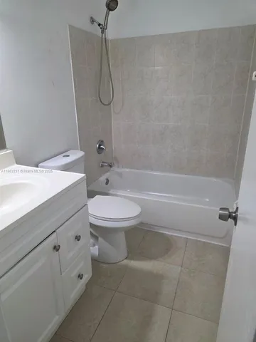a bathroom with a toilet sink and shower
