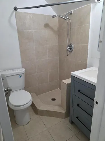 a bathroom with a toilet and shower