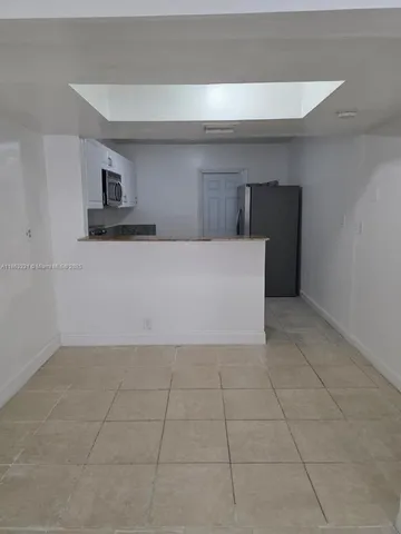 a view of kitchen with empty cabinets