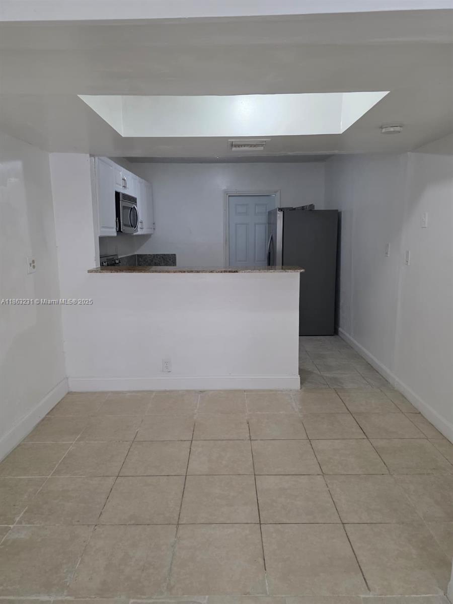 1206 Seaview, Unit 1206 North Lauderdale, FL 33068 - Photo 6 of 17 a view of kitchen with empty cabinets