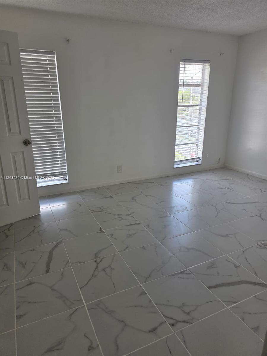 1206 Seaview, Unit 1206 North Lauderdale, FL 33068 - Photo 7 of 17 an empty room with windows