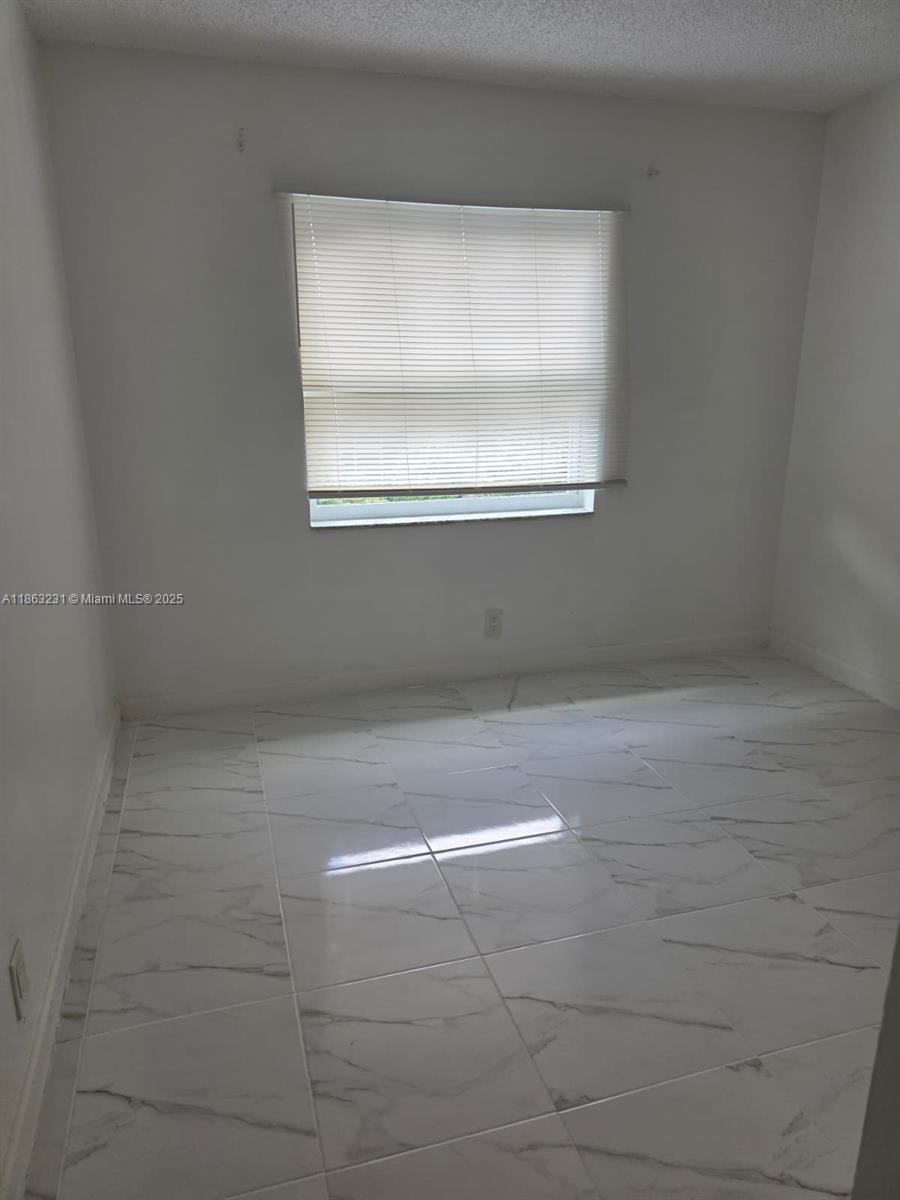 1206 Seaview, Unit 1206 North Lauderdale, FL 33068 - Photo 8 of 17 a view of a small space with wooden floor and a window
