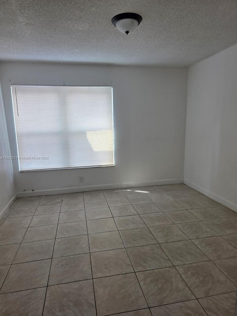 1206 Seaview, Unit 1206 North Lauderdale, FL 33068 - Photo 10 of 17 a view of an empty room with a window