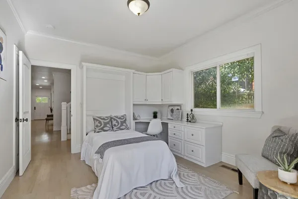 a bedroom with a bed and a window