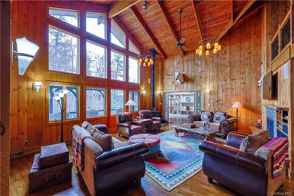 a living room with furniture a fireplace and a flat screen tv