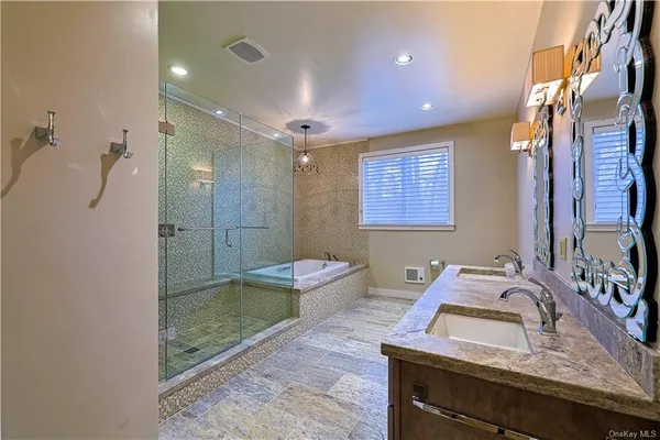 a bathroom with a sink toilet a mirror and bathtub