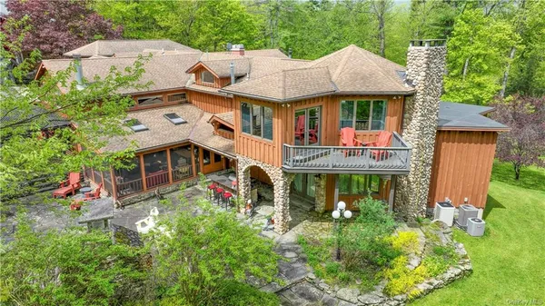 an aerial view of a house with yard swimming pool and outdoor seating