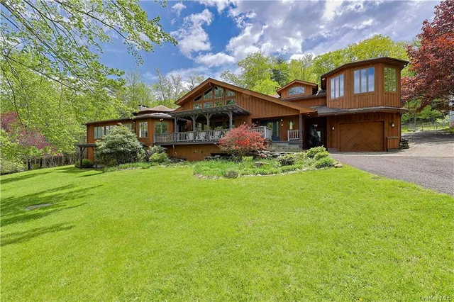 a front view of a house with a garden and plants