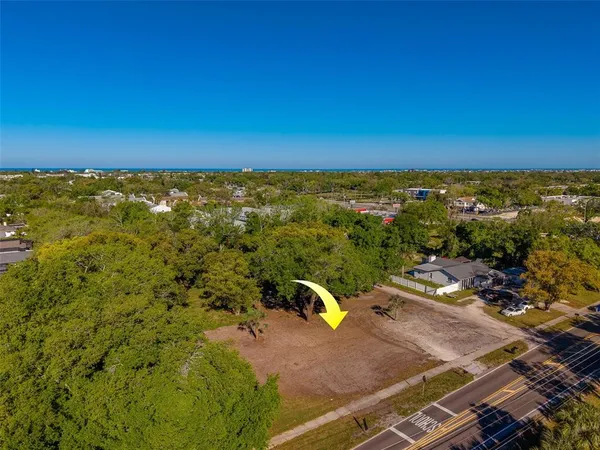 an aerial view of a house with a garden and lake view