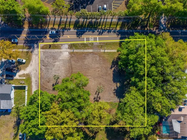a view of swimming pool with outdoor seating and plants
