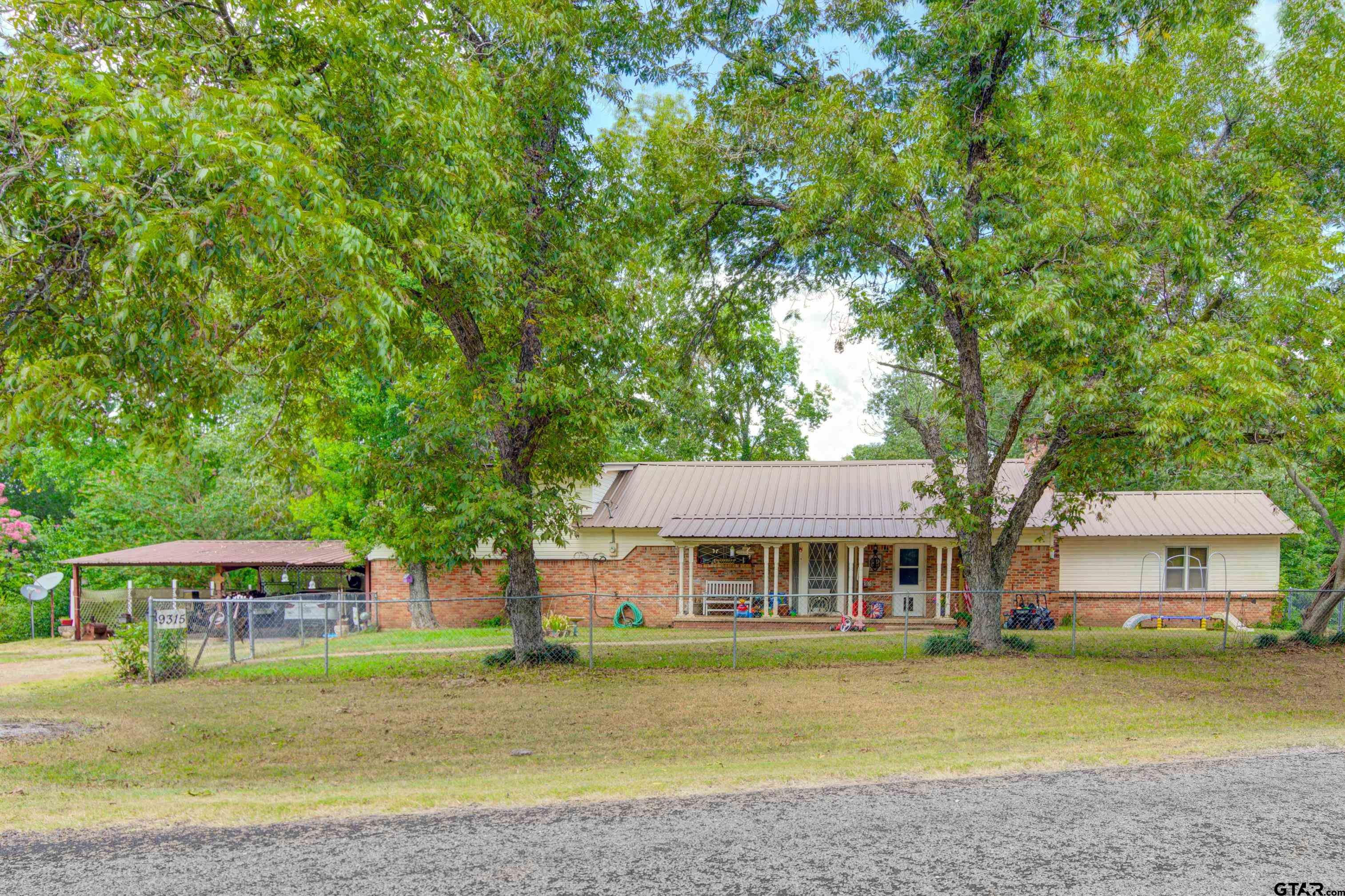 9315 Farm To Market Road 851 Rusk, TX 75785 - Photo 2 of 34 a front view of a house with a garden