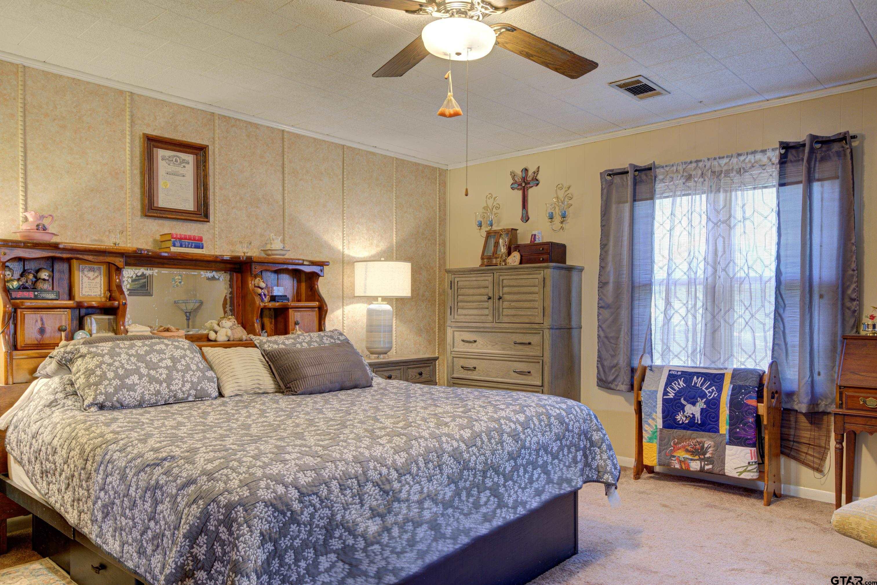 9315 Farm To Market Road 851 Rusk, TX 75785 - Photo 21 of 34 a bedroom with a bed and a chandelier