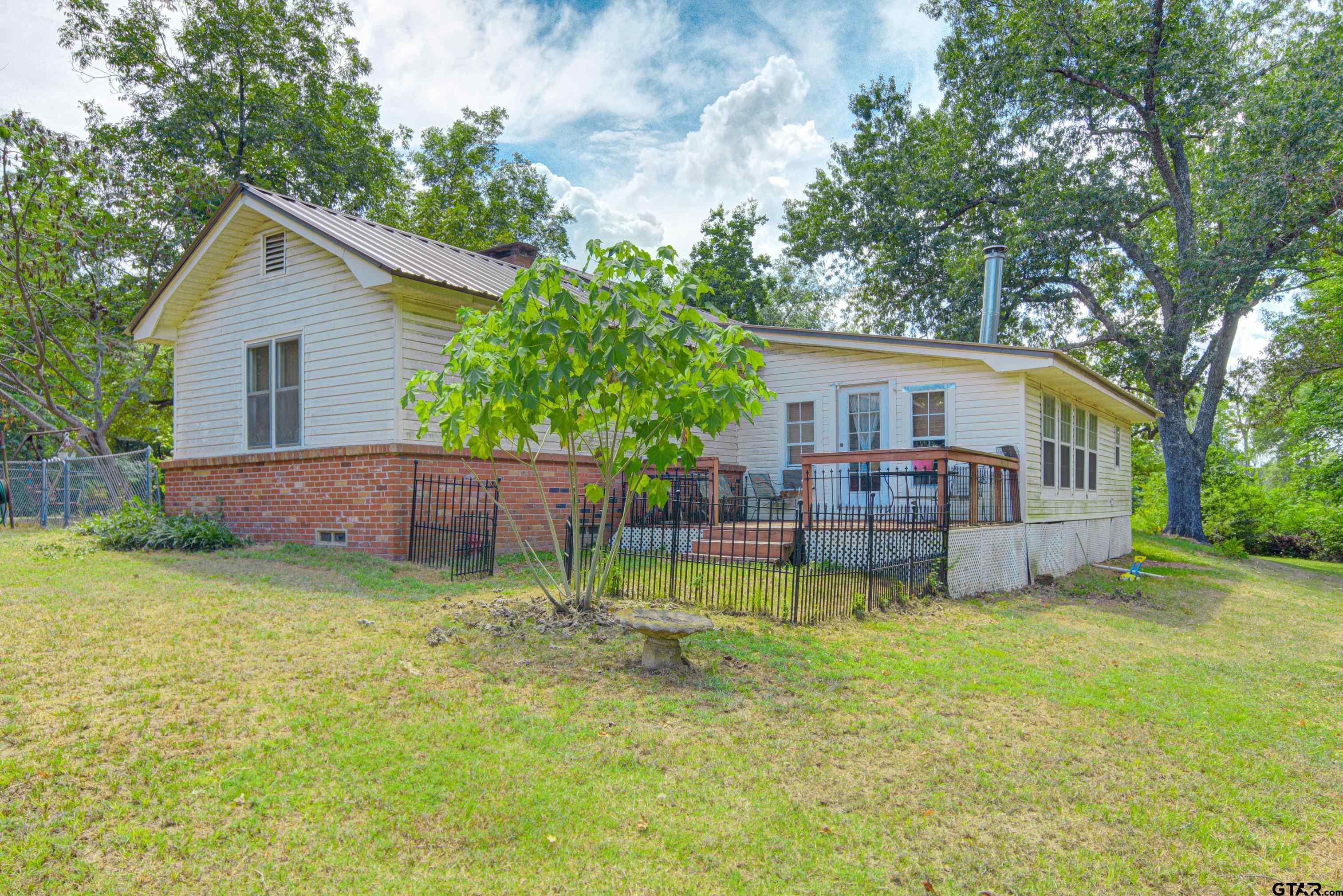 9315 Farm To Market Road 851 Rusk, TX 75785 - Photo 33 of 34 a backyard of a house with table and chairs