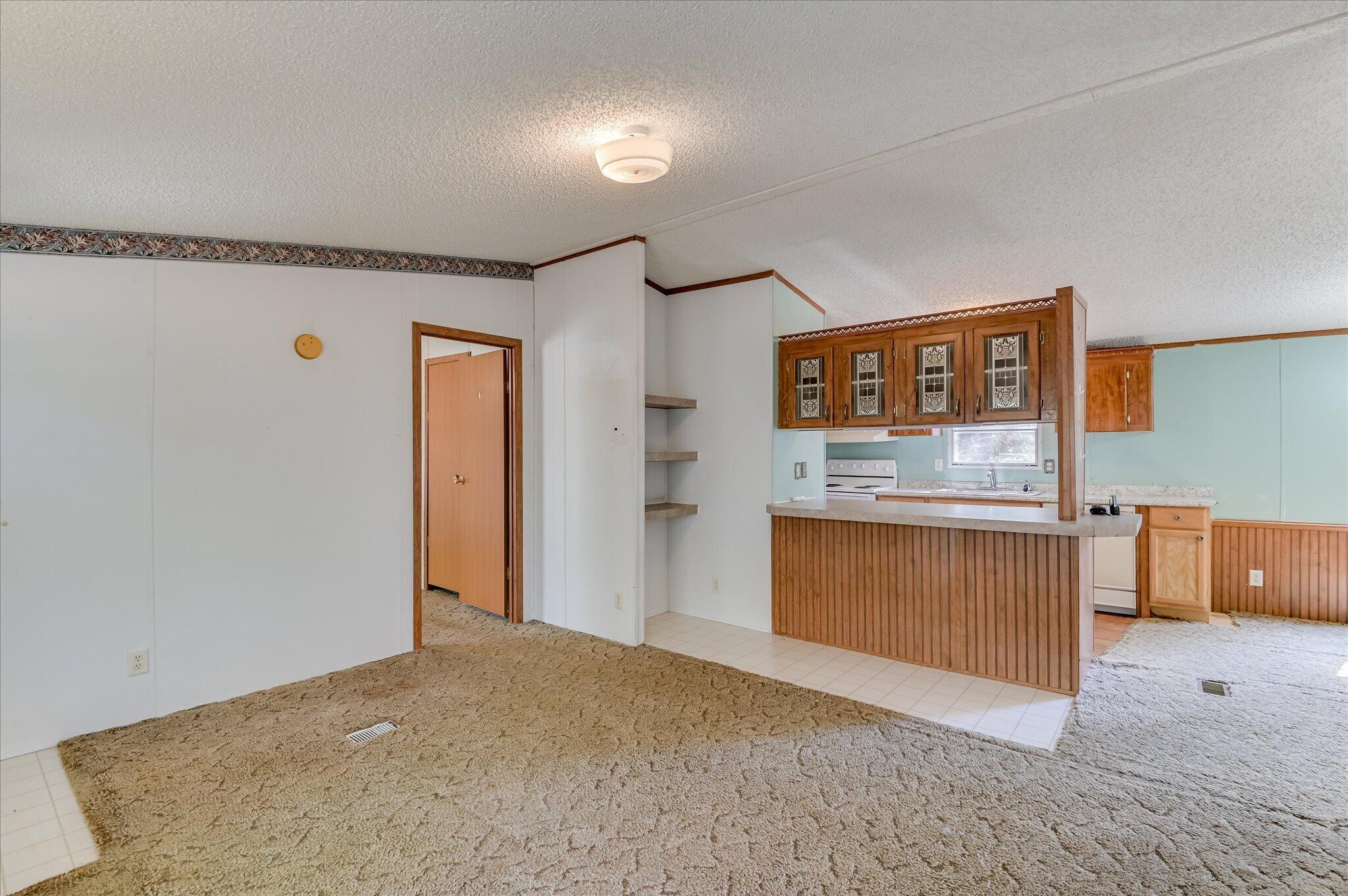 3440 Smith Road Blythe, GA 30805 - Photo 7 of 32 Living room with view of glass cabinets looking into kitchen
