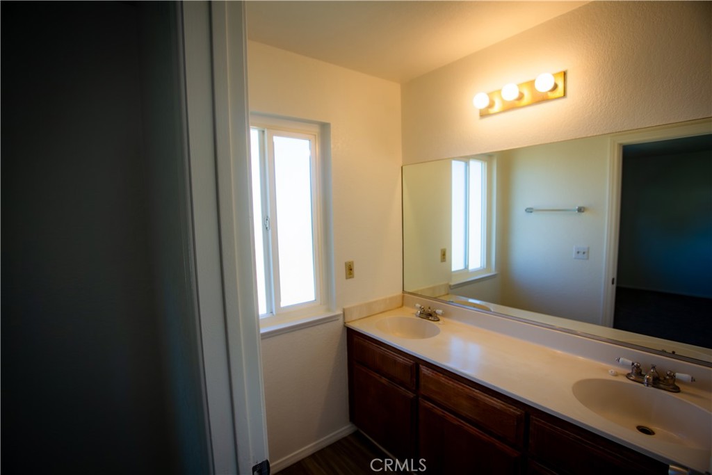 21090 Lone Eagle Road Apple Valley, CA 92308 - Photo 11 of 11 a bathroom with a sink and a mirror