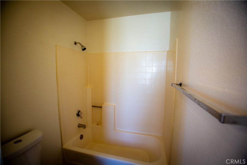 21090 Lone Eagle Road Apple Valley, CA 92308 - Photo 10 of 11 a bathroom with a bathtub and shower