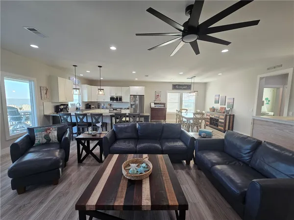 a kitchen with stainless steel appliances kitchen island granite countertop a stove top oven a sink a counter top space and cabinets