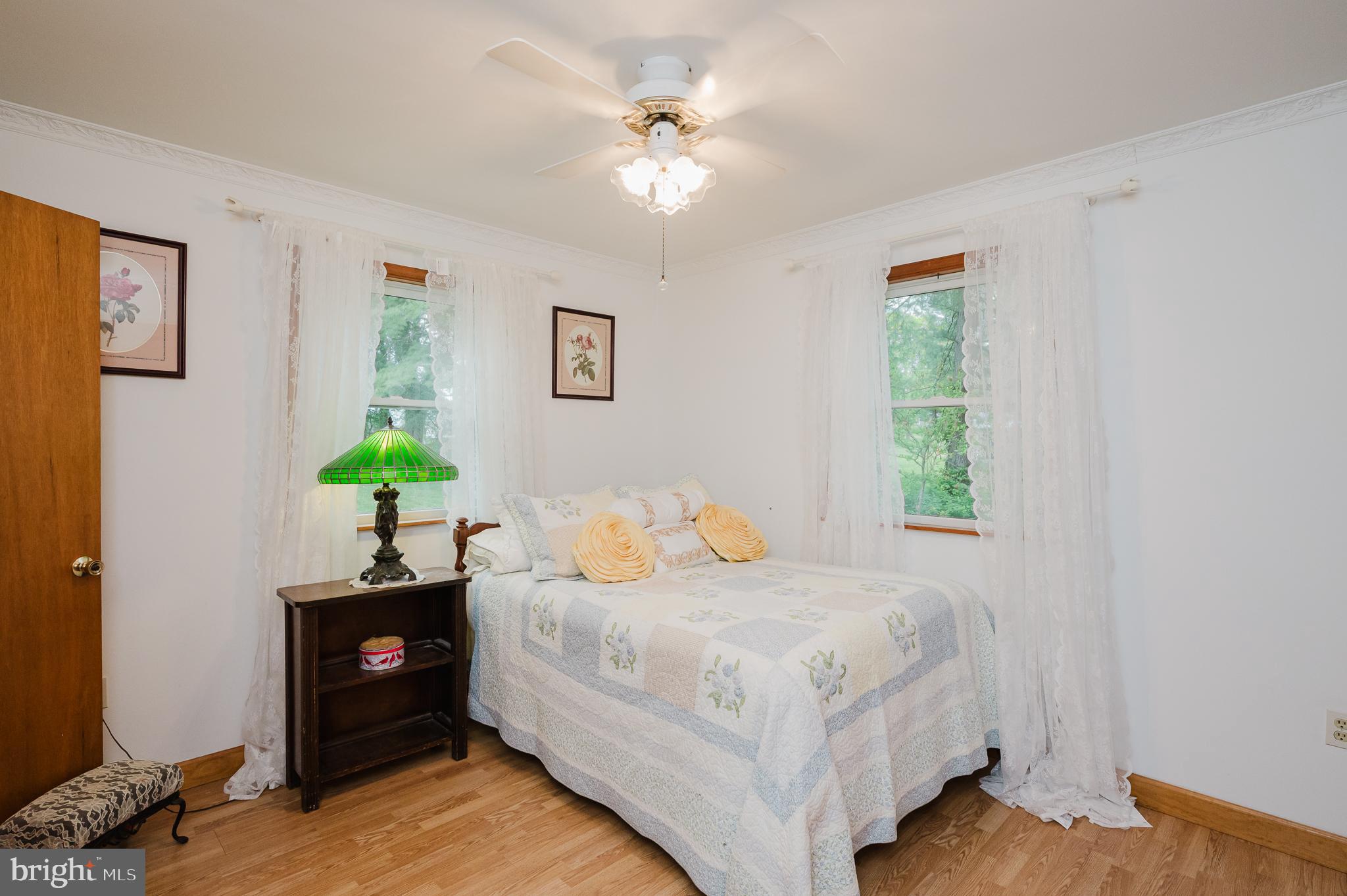 710 Magnolia Road Joppa, MD 21085 - Photo 18 of 58 a bedroom with a bed chandelier and a window