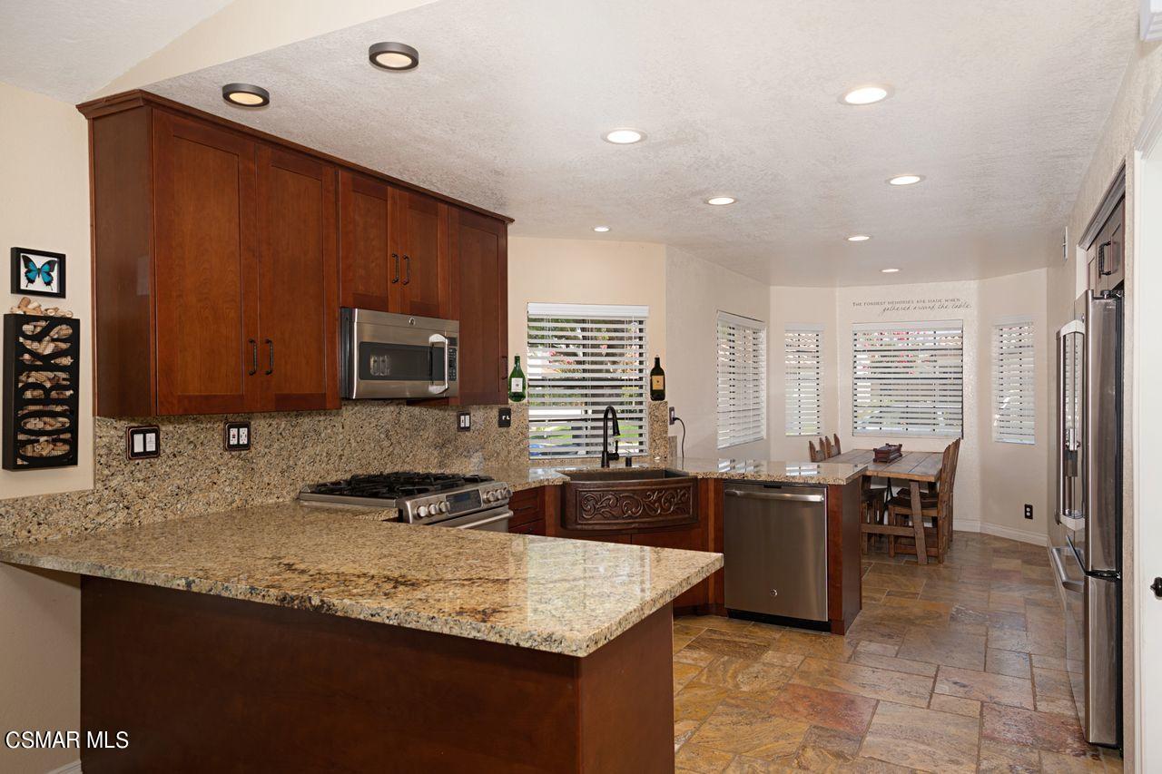 777 Congressional Road Simi Valley, CA 93065 - Photo 12 of 26 a kitchen with granite countertop sink cabinets and stainless steel appliances