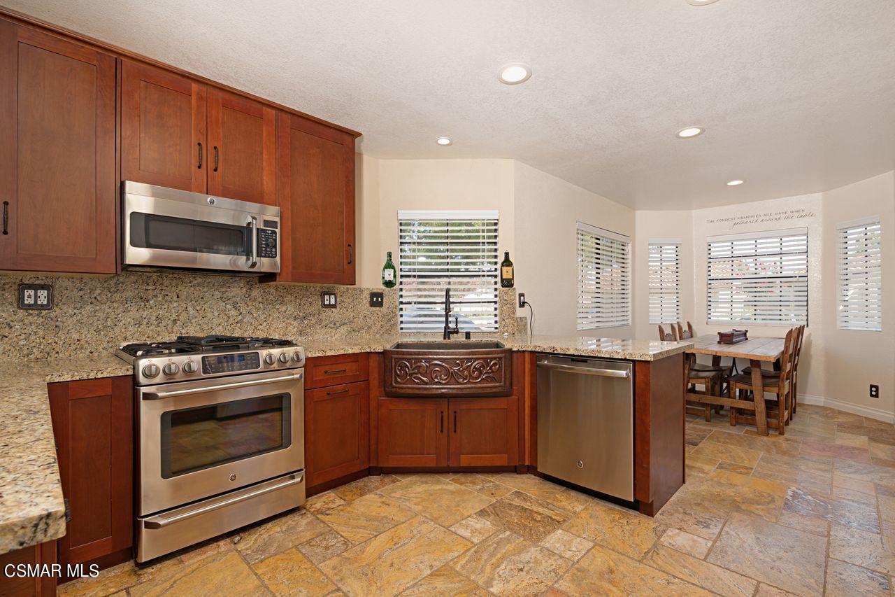 777 Congressional Road Simi Valley, CA 93065 - Photo 13 of 26 a kitchen with stainless steel appliances granite countertop a stove a sink and a microwave