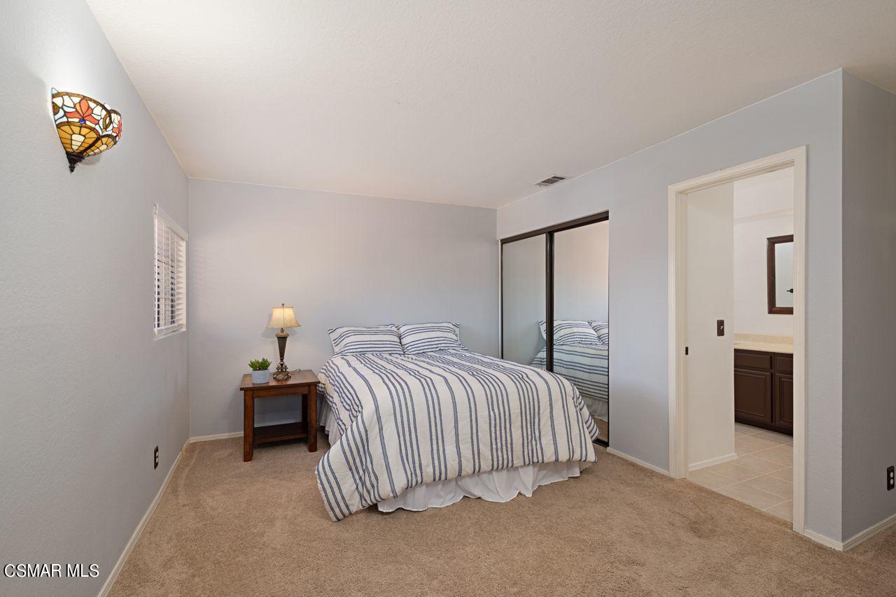 777 Congressional Road Simi Valley, CA 93065 - Photo 16 of 26 a bedroom with a bed and a lamp