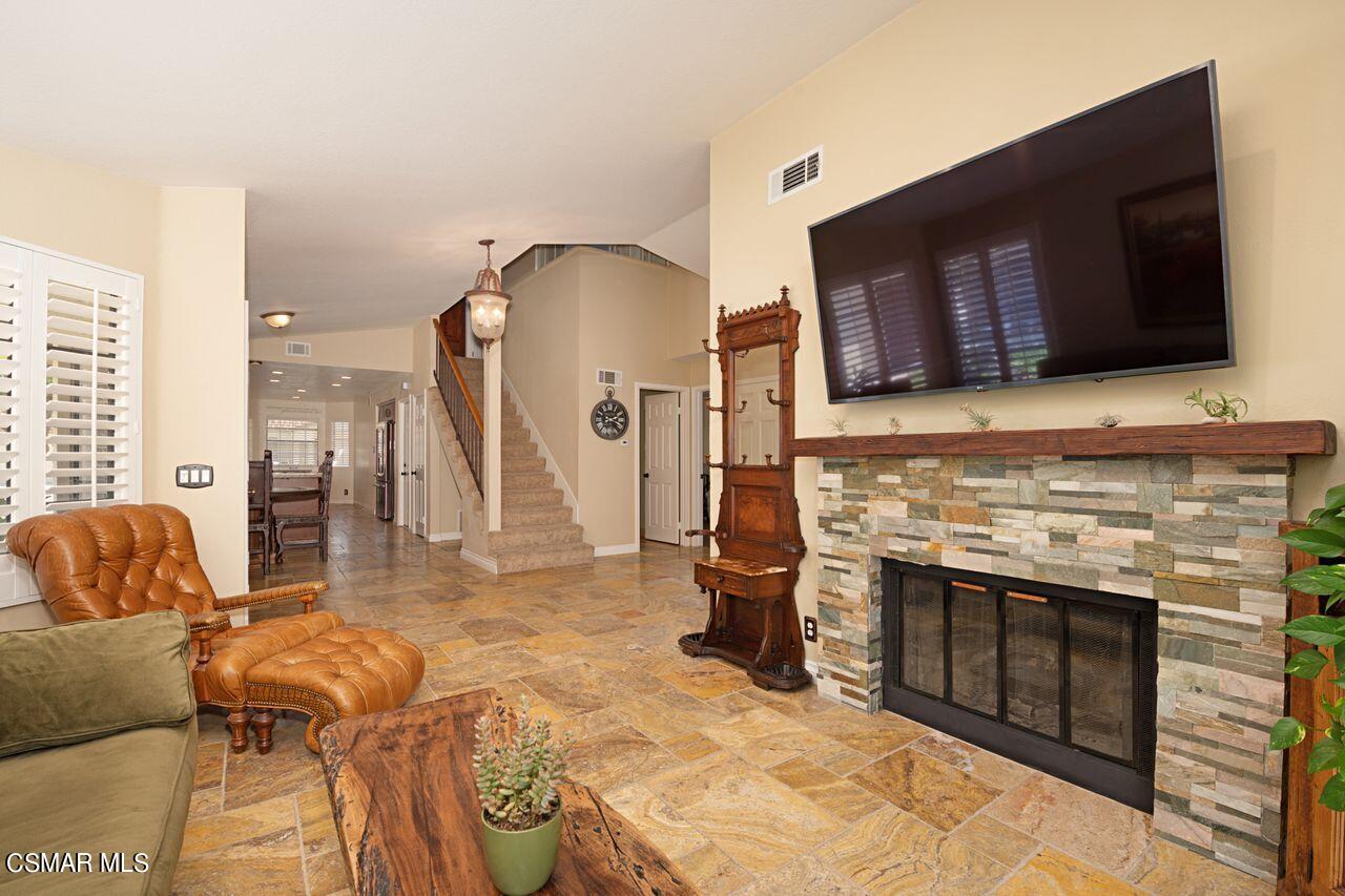 777 Congressional Road Simi Valley, CA 93065 - Photo 3 of 26 a living room with furniture a flat screen tv and a fireplace