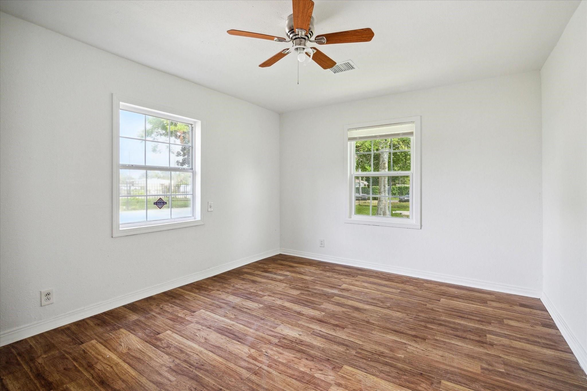 3229 Persimmon Street Houston, TX 77093 - Photo 6 of 8 a view of empty room with wooden floor and fan