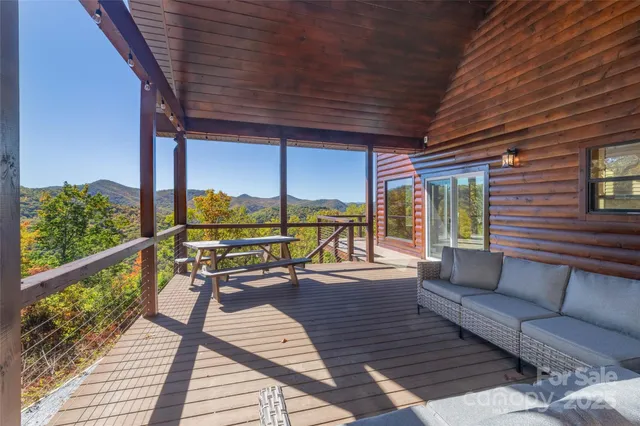 a balcony with wooden floor and outdoor seating
