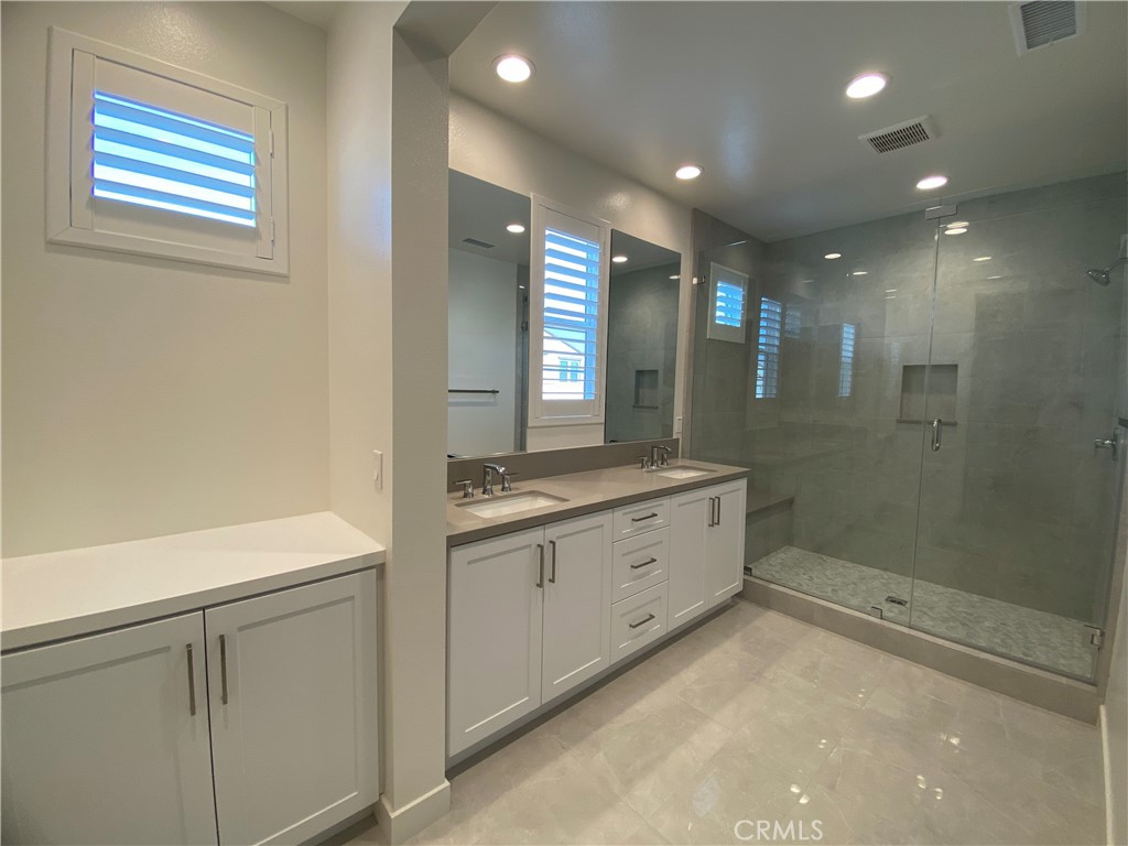 602 Jasper Street Rancho Mission Viejo, CA 92694 - Photo 11 of 18 a bathroom with a double vanity sink toilet and shower