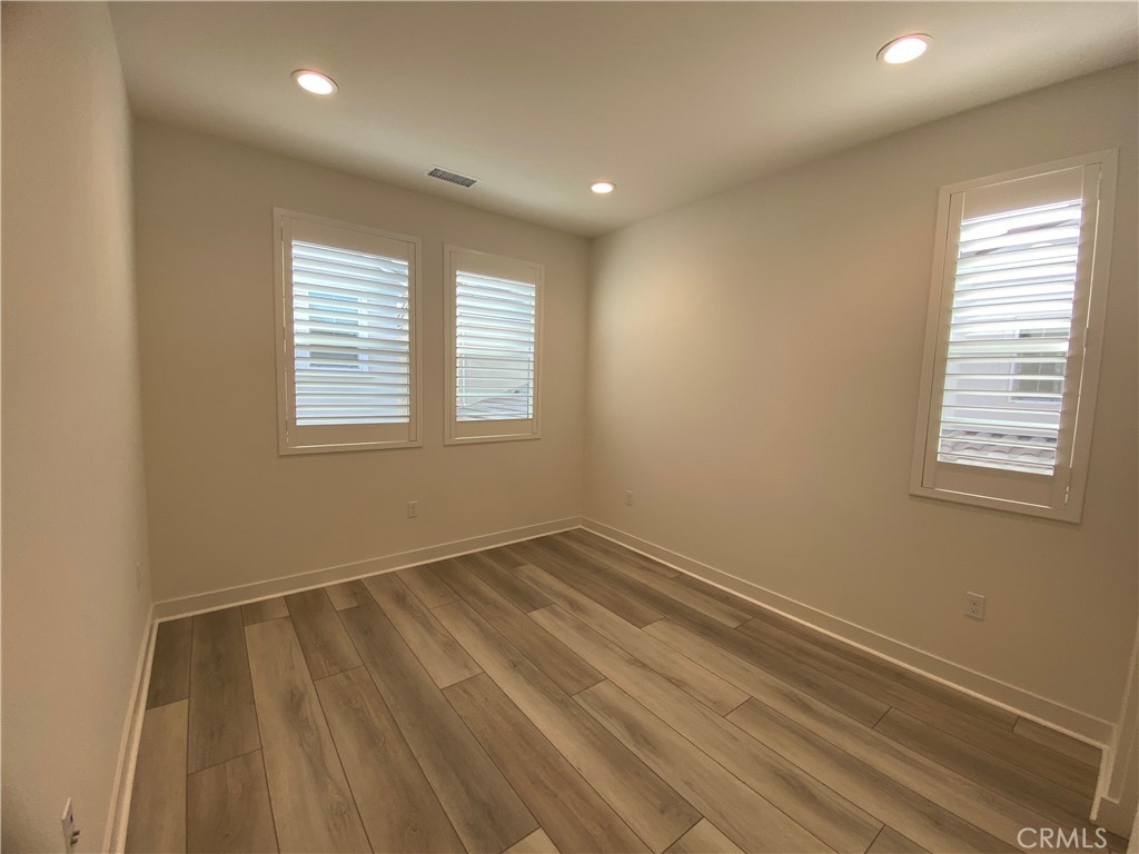 602 Jasper Street Rancho Mission Viejo, CA 92694 - Photo 14 of 18 a view of an empty room with wooden floor and a window