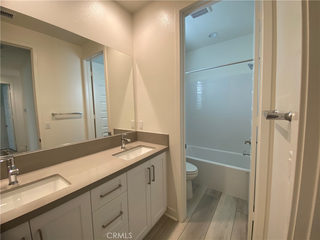 602 Jasper Street Rancho Mission Viejo, CA 92694 - Photo 18 of 18 a bathroom with a granite countertop sink toilet and shower