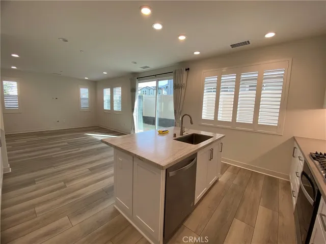 a kitchen with granite countertop a sink and a stove top oven