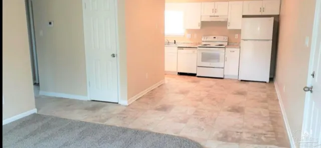 a white toilet sitting next to a bath tub