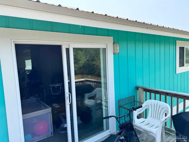 a view of a house with a yard and palm trees