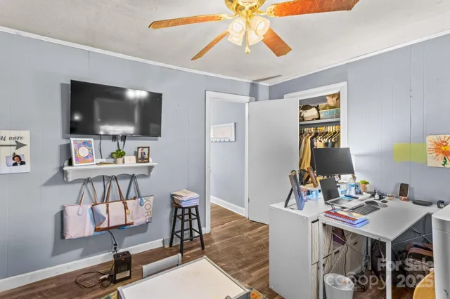 a view of a livingroom with furniture and a flat screen tv
