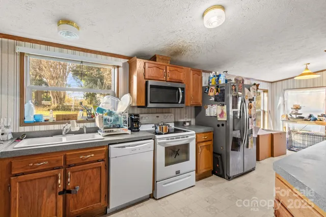 a kitchen with a sink stove and refrigerator