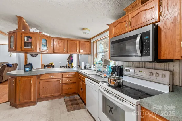 a kitchen with stainless steel appliances granite countertop a sink and cabinets