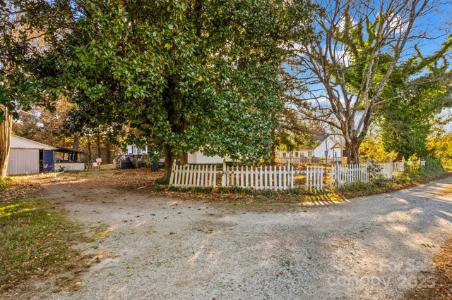 a view of a yard with large trees