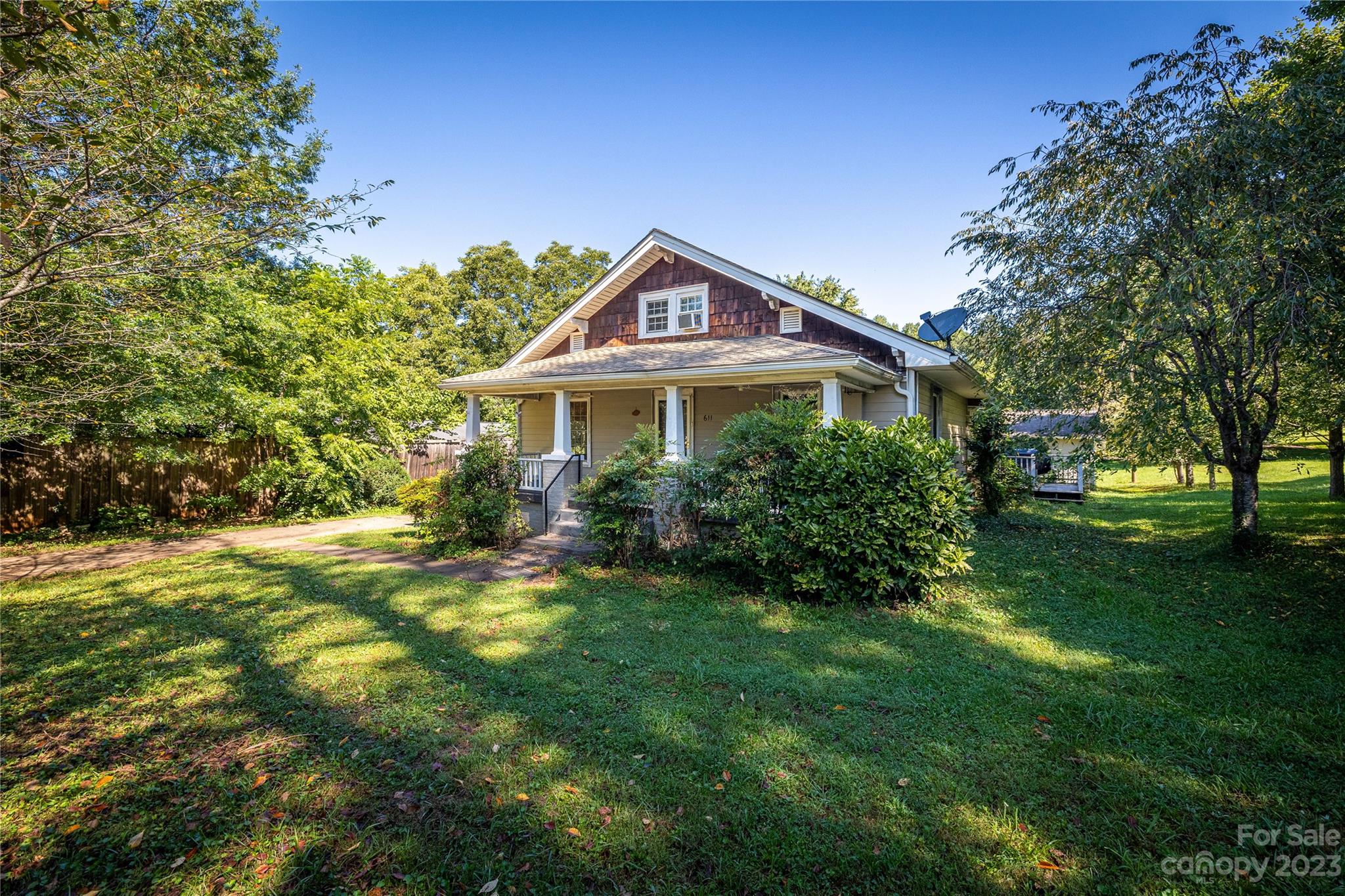 611 Vinearden Road Morganton, NC 28655 - Photo 2 of 32 a yellow house with a small yard and trees