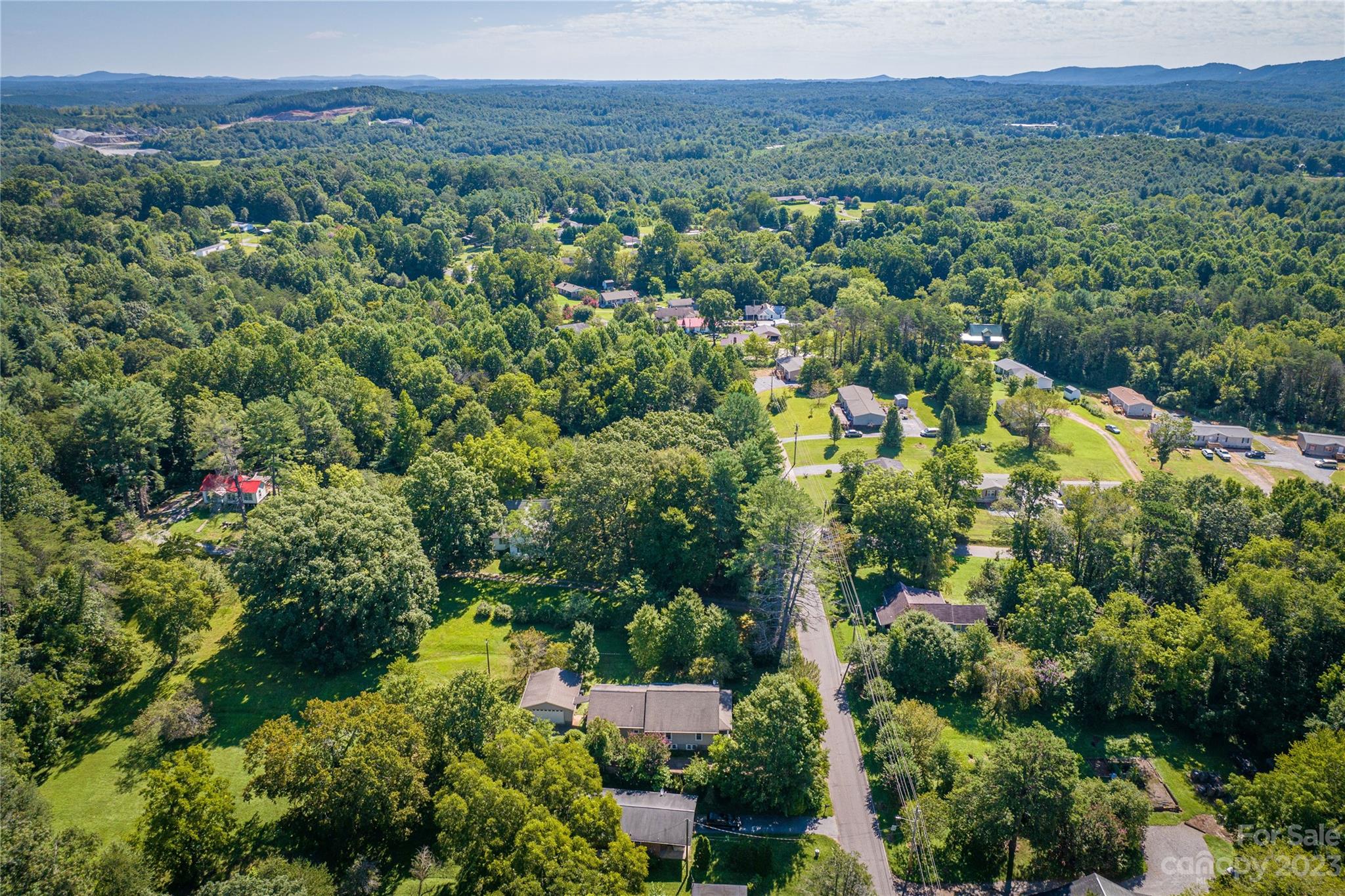 611 Vinearden Road Morganton, NC 28655 - Photo 26 of 32 an aerial view of a houses with a lush green hillside