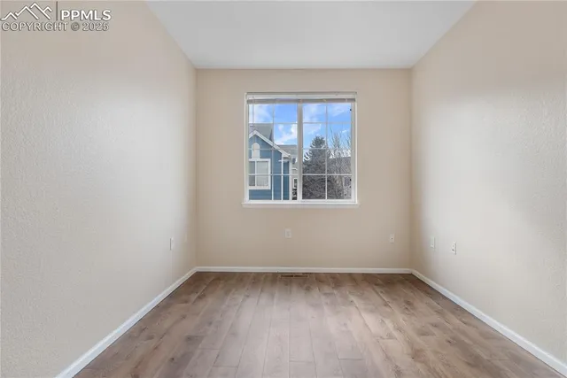 a view of hallway with wooden floor
