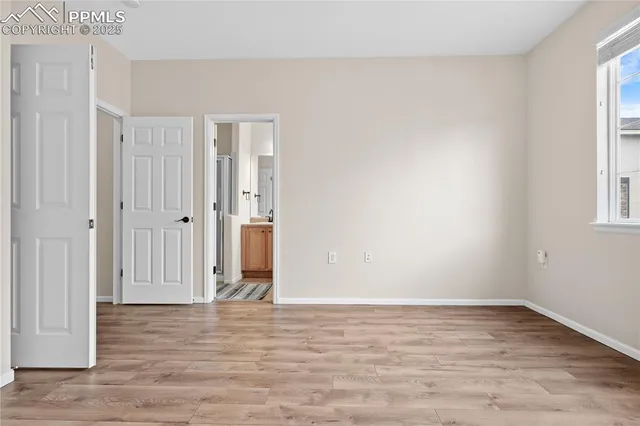 a view of a room with wooden floor