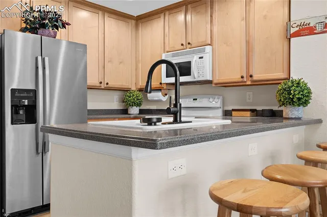 a view of kitchen with furniture and a fireplace