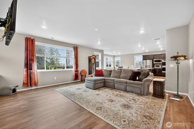 a living room with furniture window and wooden floor